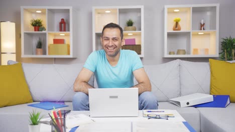 Home-office-worker-man-smiles-at-camera.